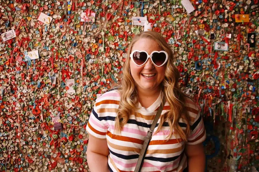 Standing in front of the famous Gum Wall at Pike Place Market in Seattle