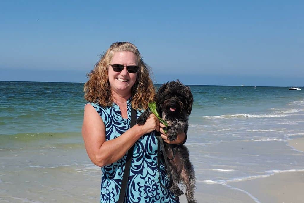 Sherry and Shelby on a beach show that traveling with a dog in Mexico is a great idea