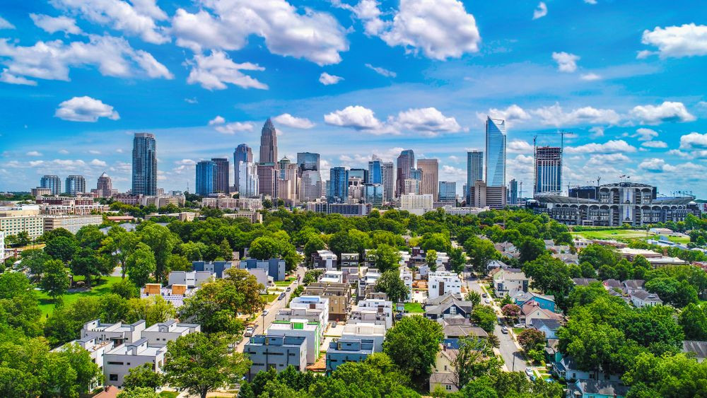 An aerial view of Charlotte, NC, showing its modern skyline and vibrant urban atmosphere