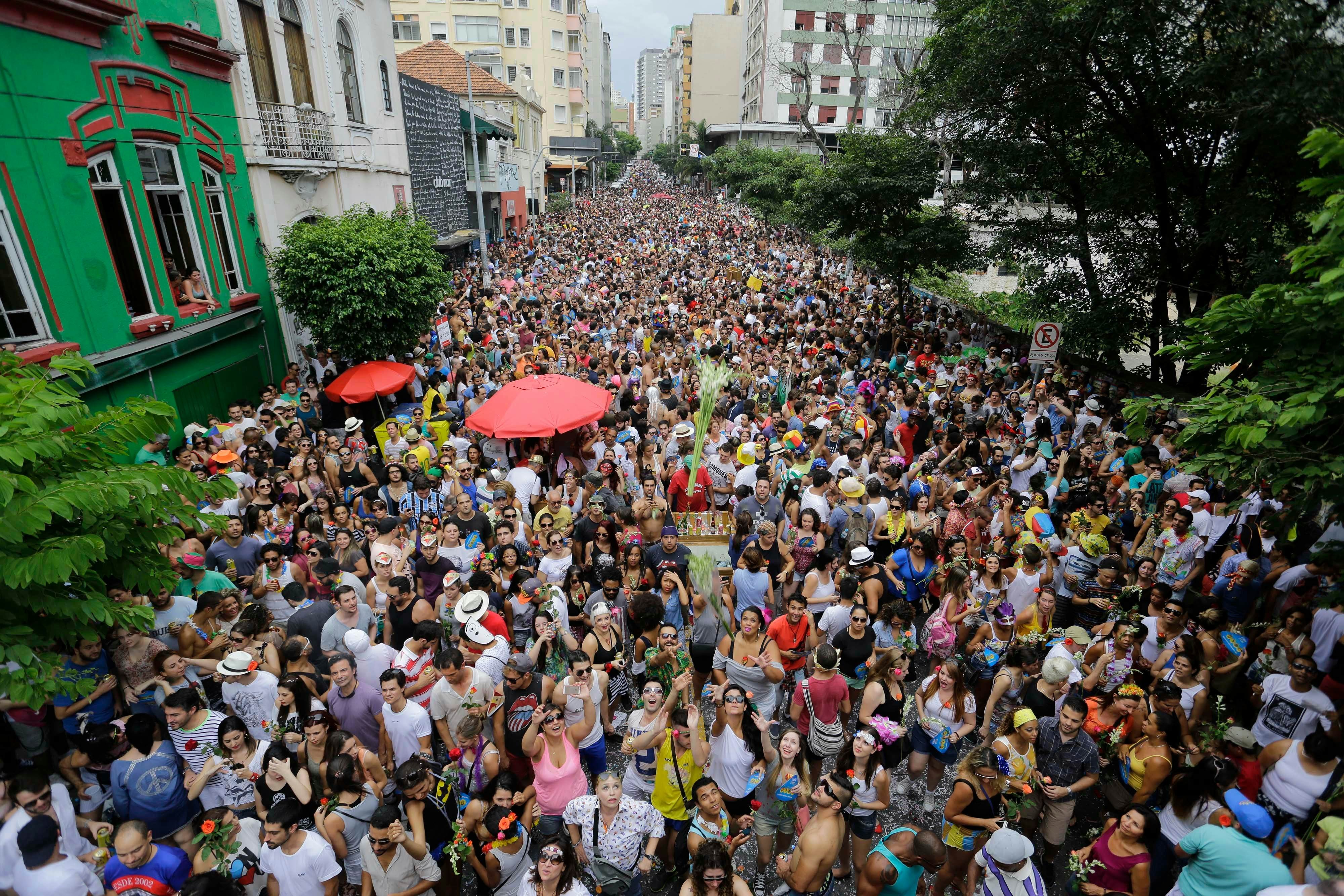 A big crowd sing and dance during a bloco carnival parade in Augusta street, downtown São Paulo, Brazil, showcasing the city's vibrant carnival spirit