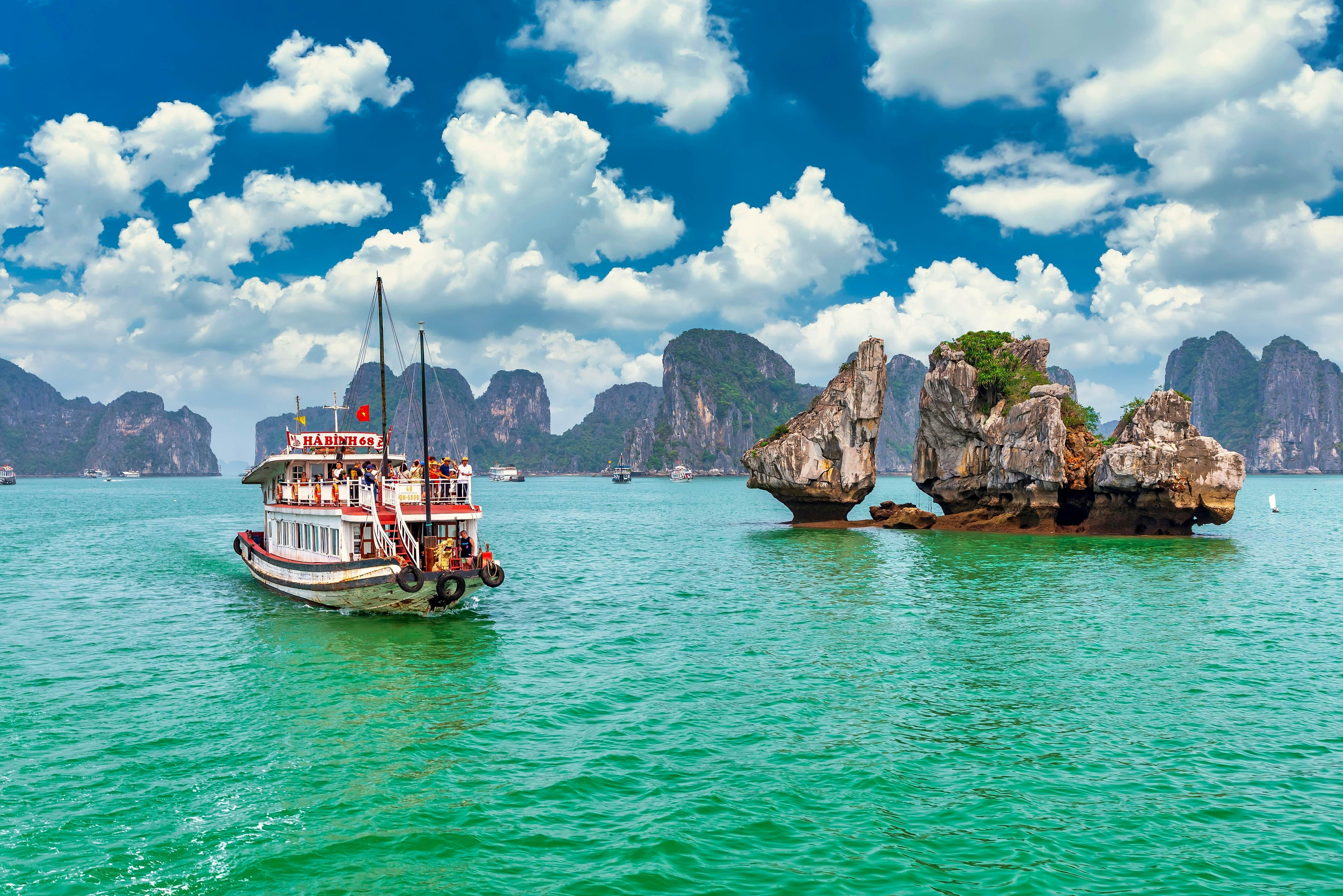 Boat cruises past karst outcrops in Halong Bay, Vietnam