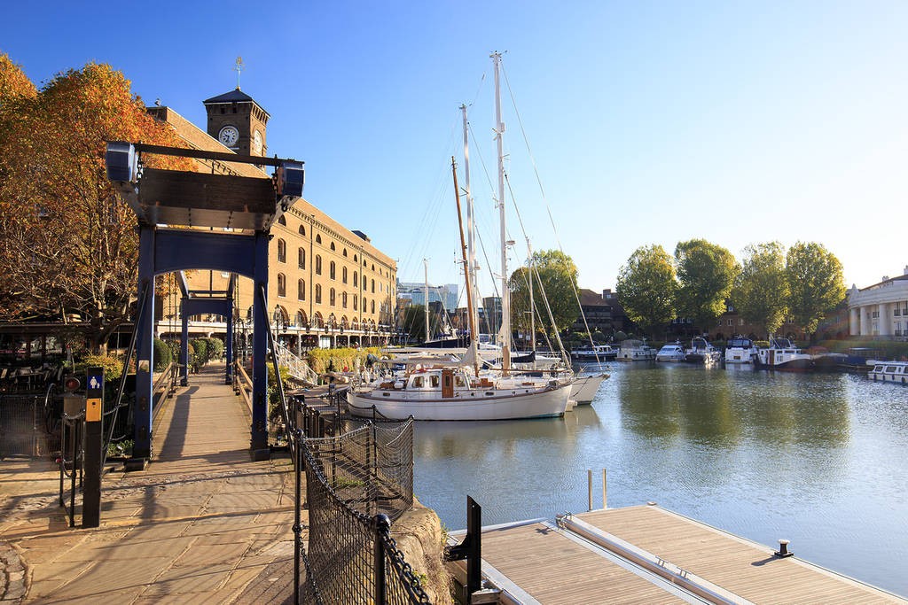 A picturesque view of Regent's Canal with colorful houseboats, a unique walking route to add to your London tourism map
