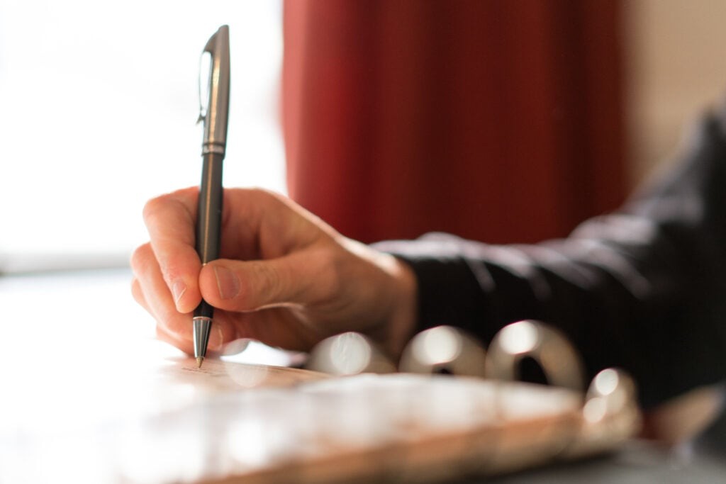 A person signing their paperwork after negotiating RV price