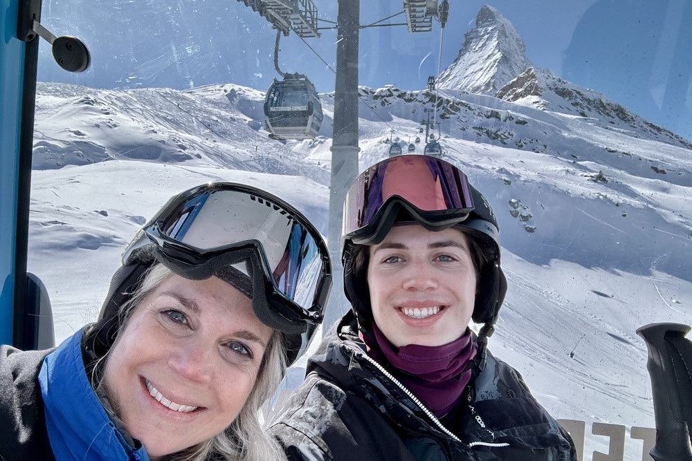 Traveler riding the gondola with the Matterhorn in the background, showcasing the Swiss Alps
