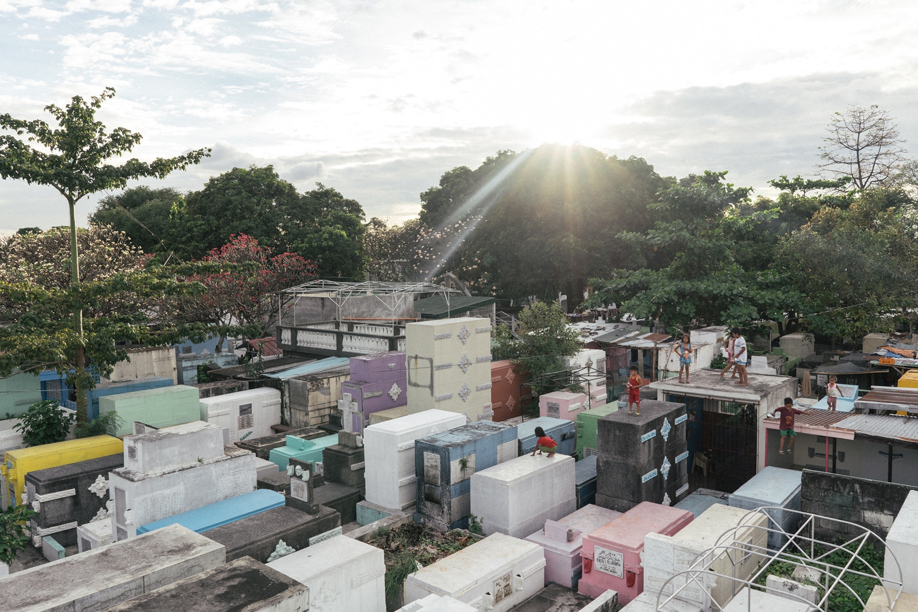 Residents jump from grave to grave in the city’s largest cemetery.