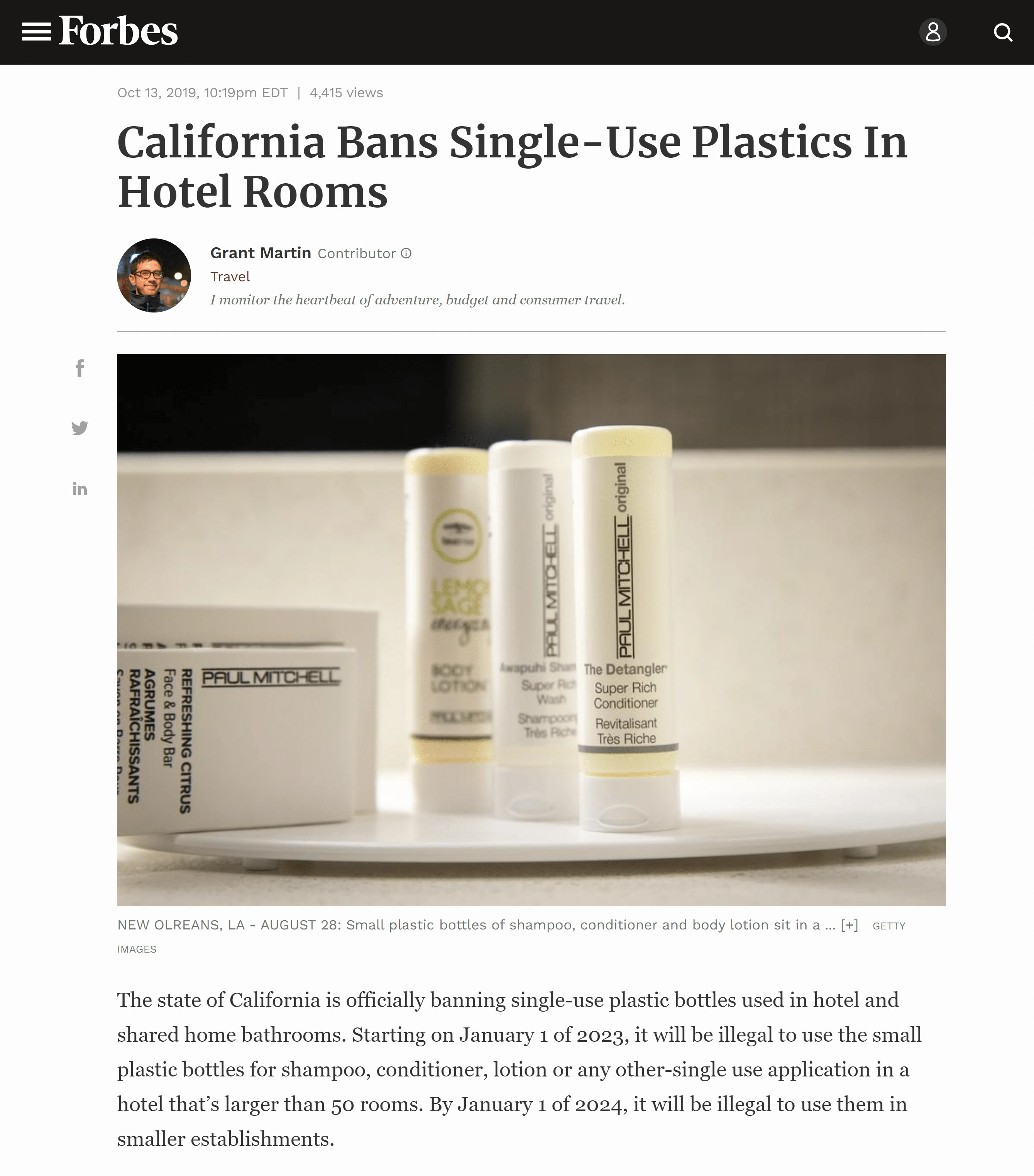 Hotel staff replenishes toiletries in reusable dispensers in a modern bathroom, showcasing efforts to reduce single-use plastics in the hospitality industry.