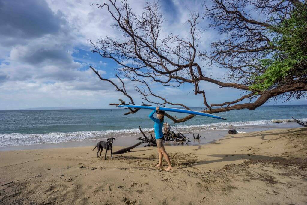 Solo female traveler taking surf lessons in Maui
