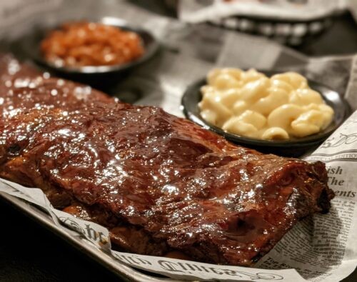 BBQ pork ribs at Sons of Smoke in Loudon, TN, displayed with sauces