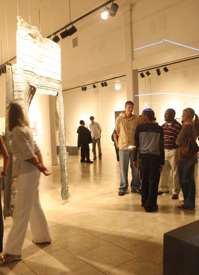 Visitors admiring the artwork on display inside a contemporary museum