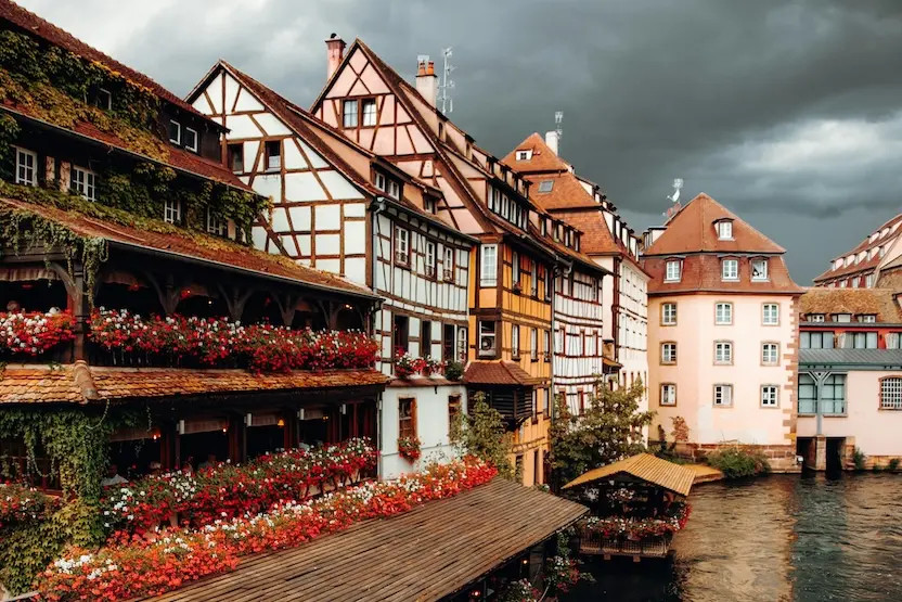 Classic half-timber buildings on a cloudy day in Strasbourg, France.