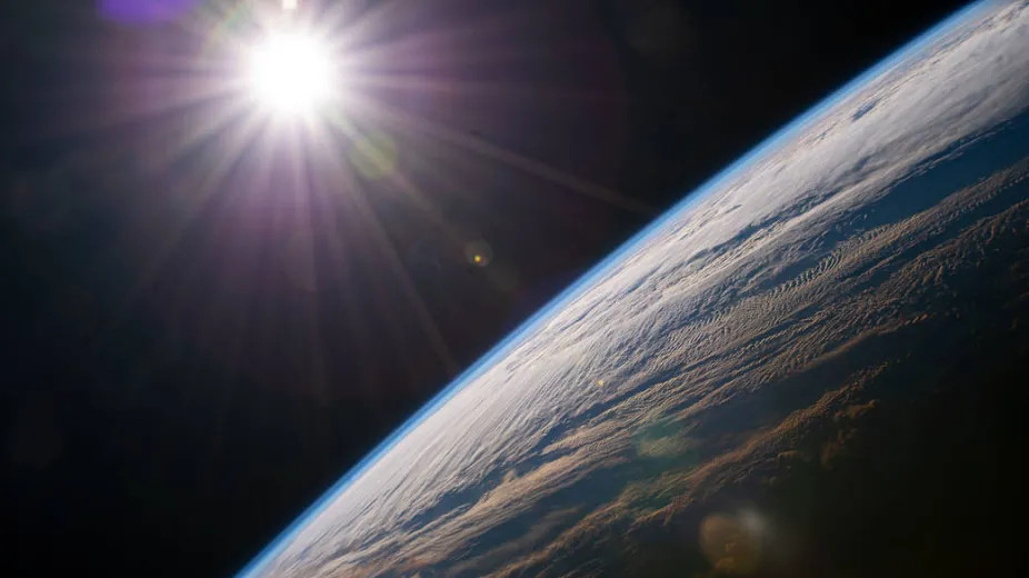From its vantage point millions of miles away, the Sun provides Earth with the energy it needs to thrive, a fact beautifully captured in this NASA image.
