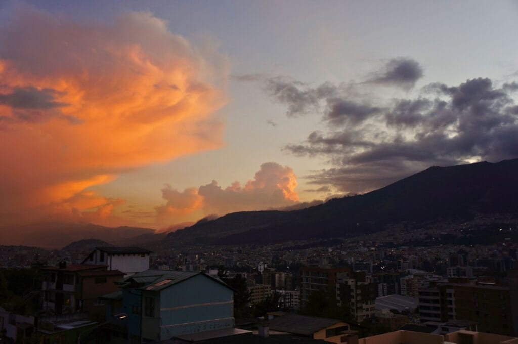 Sunset over Quito, Ecuador, capturing the city's skyline and the beauty of the Andean landscapes for Quito tourism