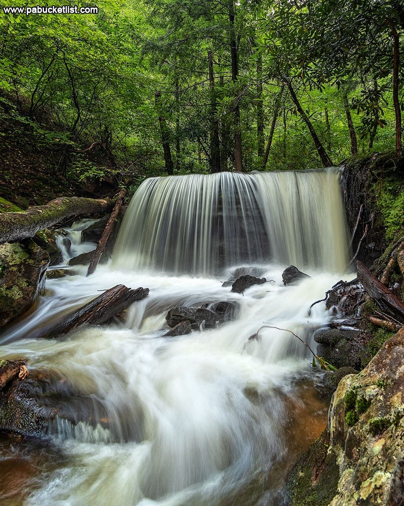 A serene waterfall in Elk County, PA, showcasing the region's natural beauty and hidden gems for adventurous travelers.