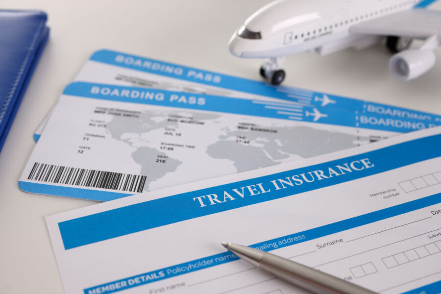 Travel insurance form and airplane tickets