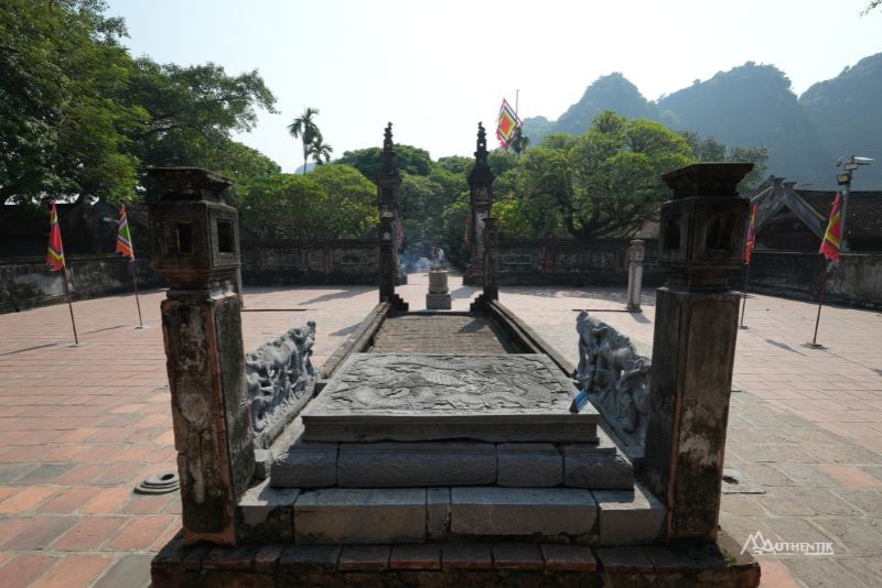 Tourists at Dinh King Temple, Ninh Binh, capturing the historical ambiance and architectural splendor of the site