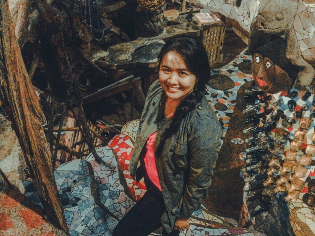 Traveler enjoying the artistic ambiance at Ili-Likha Artists’ Wateringhole, surrounded by unique and colorful art installations