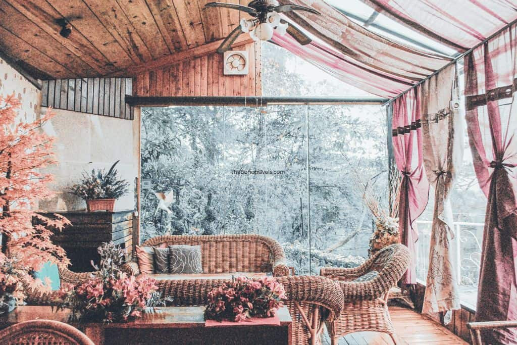 Outdoor seating at Secret Garden Restaurant and Cafe in Baguio, surrounded by lush greenery and offering a peaceful dining experience