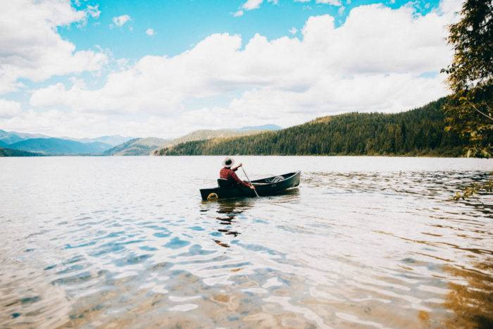 Person in a canoe paddling through Priest Lake towards Upper Priest Lake, Northern Idaho.