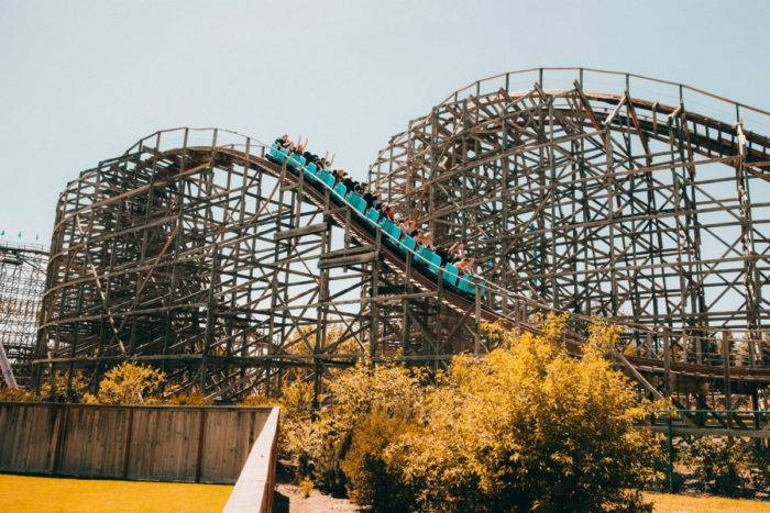 Rollercoaster with riders going down a hill at Silverwood Theme Park, Northern Idaho.