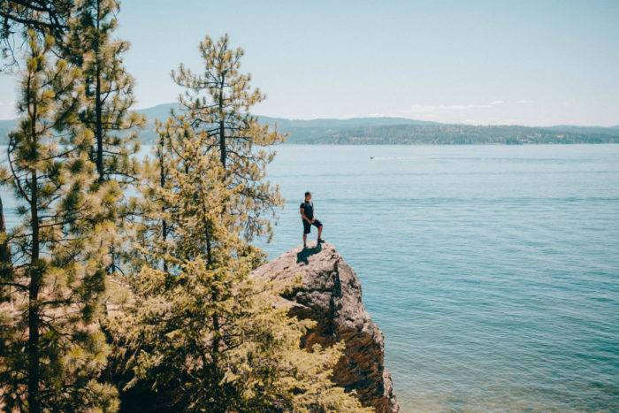 Man on rock overlooking Lake Coeur d'Alene, Tubbs Hill, Northern Idaho.