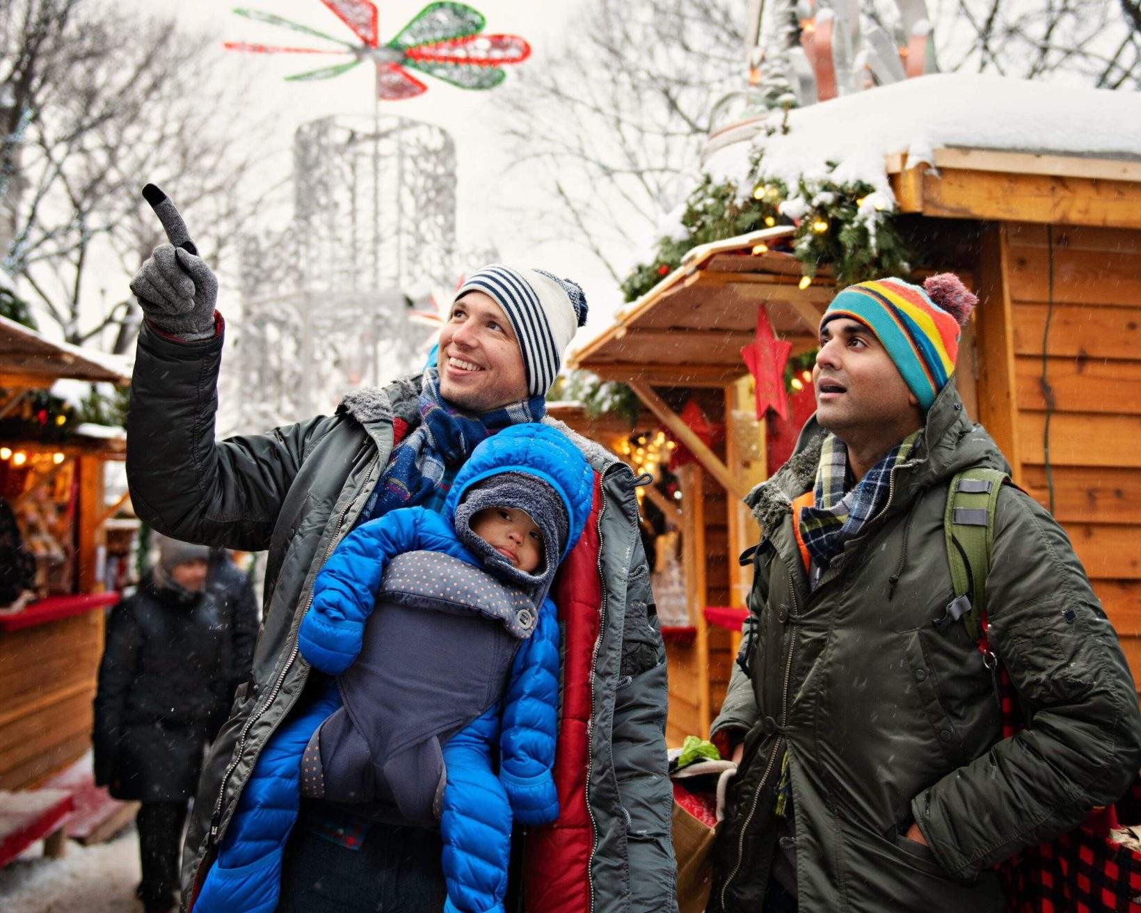 A family at a Christmas market, highlighting the importance of having necessary travel documents ready.