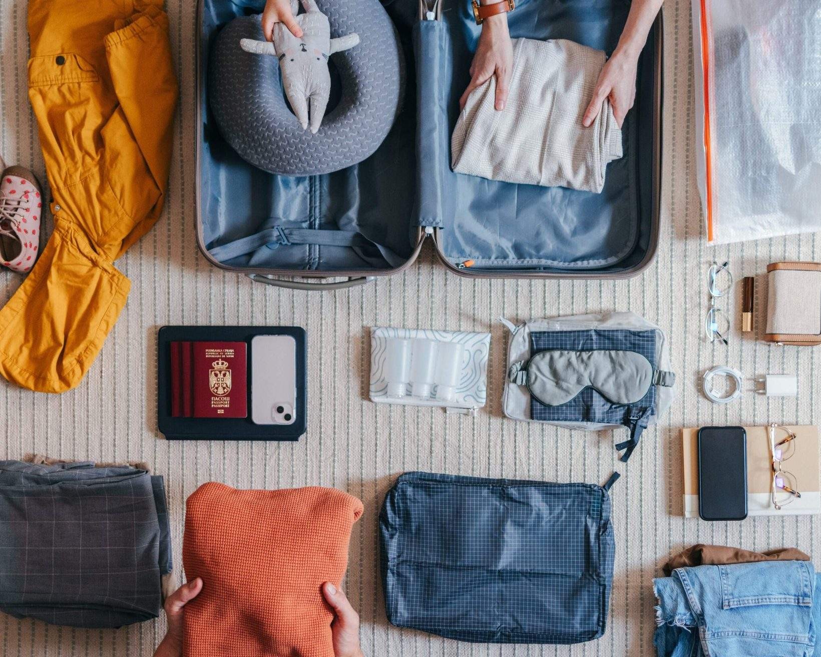 A family packing for a trip, including passports and other travel essentials.