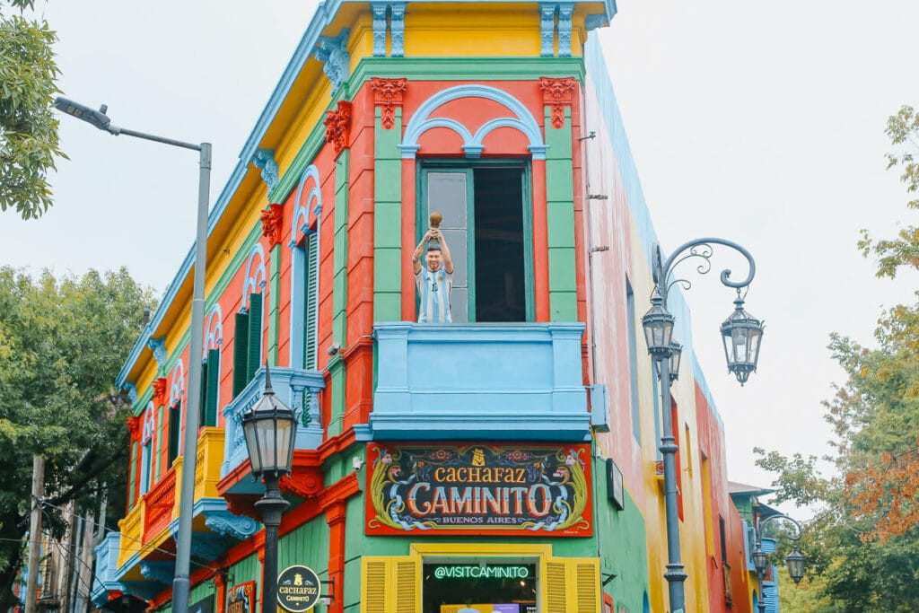 Lionel Messi statue on a rainbow colored building in Buenos Aires' Caminito
