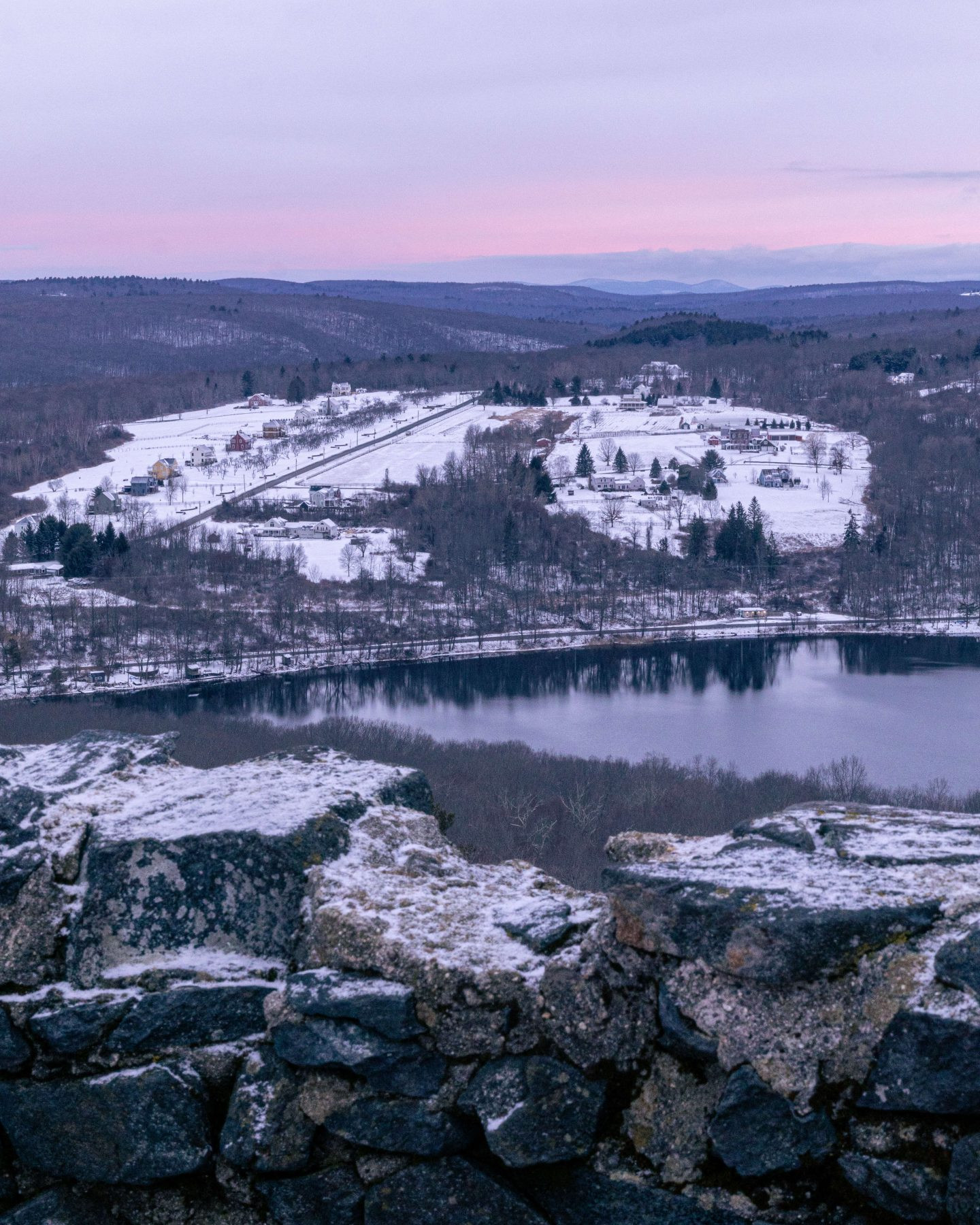 mount tom tower in litchfield at sunrise with snow in distance and pink skies