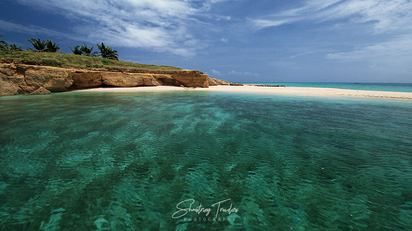 Pristine white sandbar and turquoise waters of Tinalisayan Island, Burias