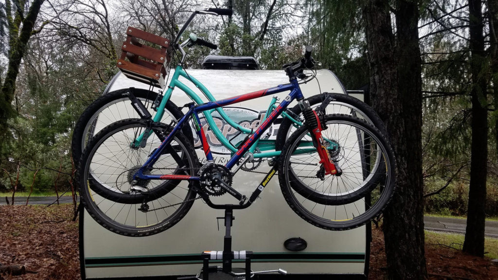 Image showing an RV with bikes mounted on a hitch riser on the trailer’s tongue, providing an alternative to rear hitches