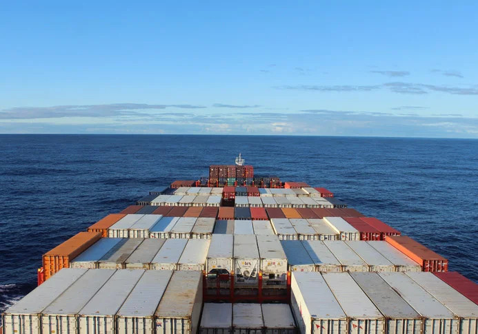 Cargo ship traveling from USA to Europe, showcasing a sustainable travel option
