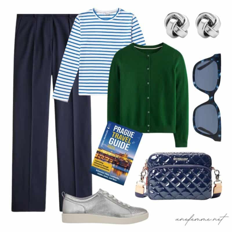 Travel outfit idea with navy trousers, striped tee, green cashmere cardigan, silver sneakers.