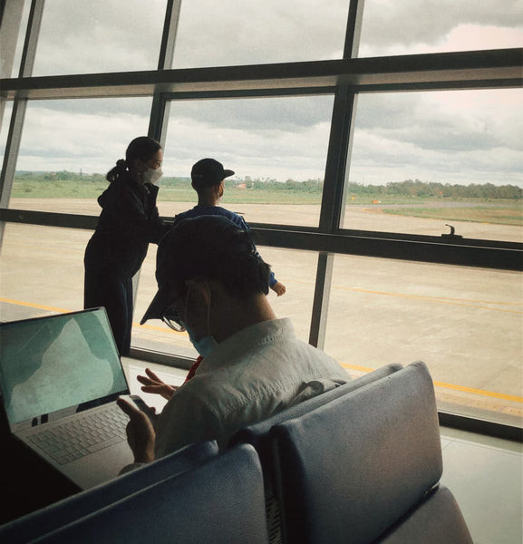 Man sitting at airport with luggage
