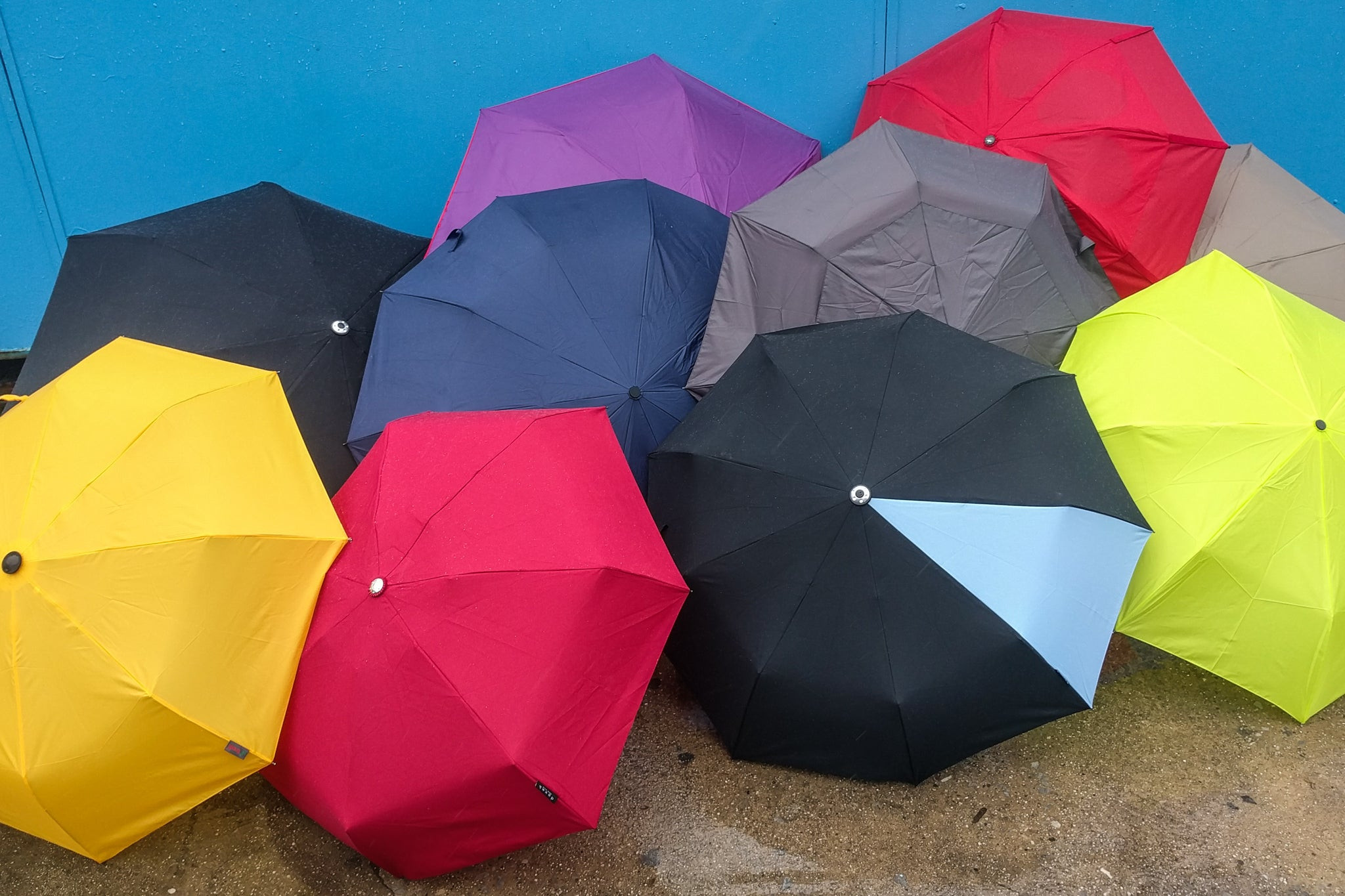 Colorful umbrellas open on the ground