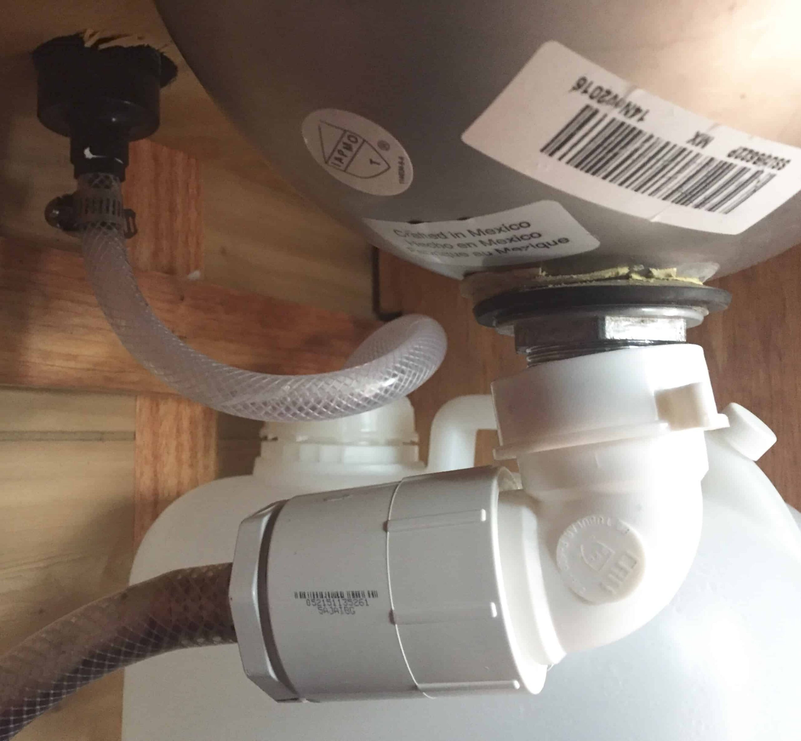 Van plumbing system with a water pump, containers, and sink