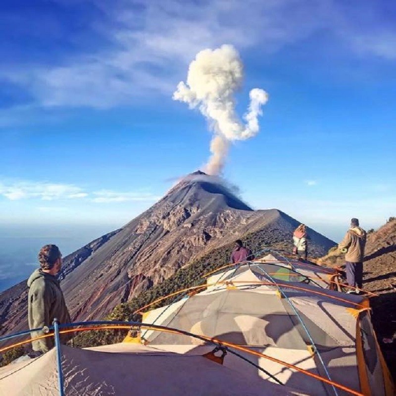 Volcano tourism as it should be done with a group of tourists and a guide.