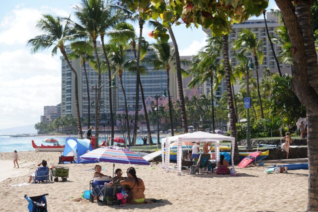 Families enjoying time at Waikiki Beach.