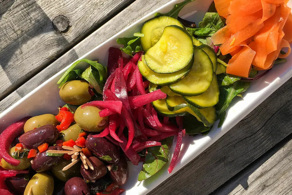 Sample Derry's sustainable food scene with colorful sliced vegetable pickles, highlighting local flavors.