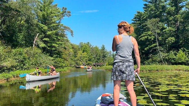 Kayaking in Waupaca's Chain O' Lakes, surrounded by lush greenery