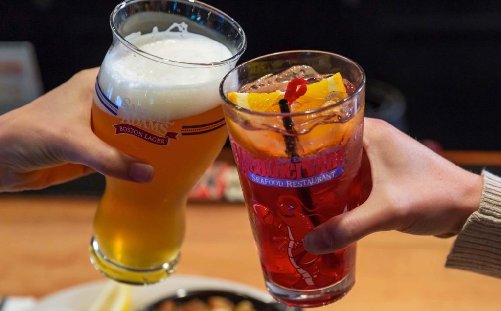 two people cheers drinks