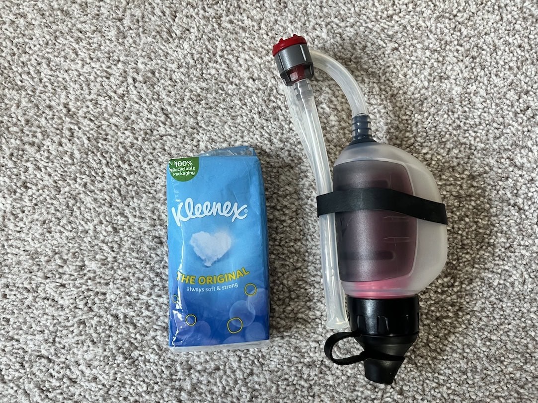 MSR trailshot next to a pocket sized Kleenex for scale