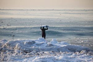 Winter surfing in Cow Bay, Nova Scotia known for its excellent waves