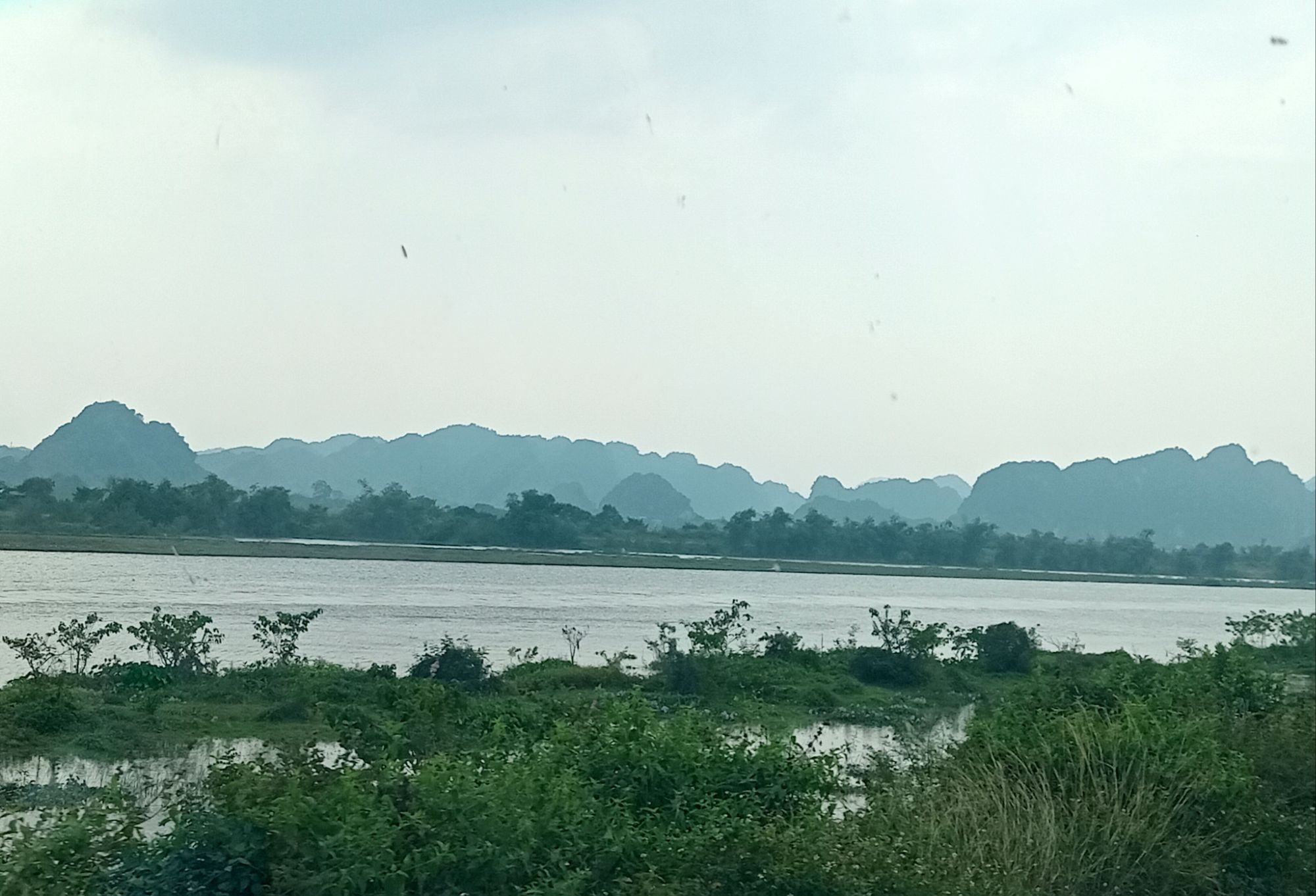 Approaching the Bai Dinh Complex with stunning silhouettes of mountains in the distance