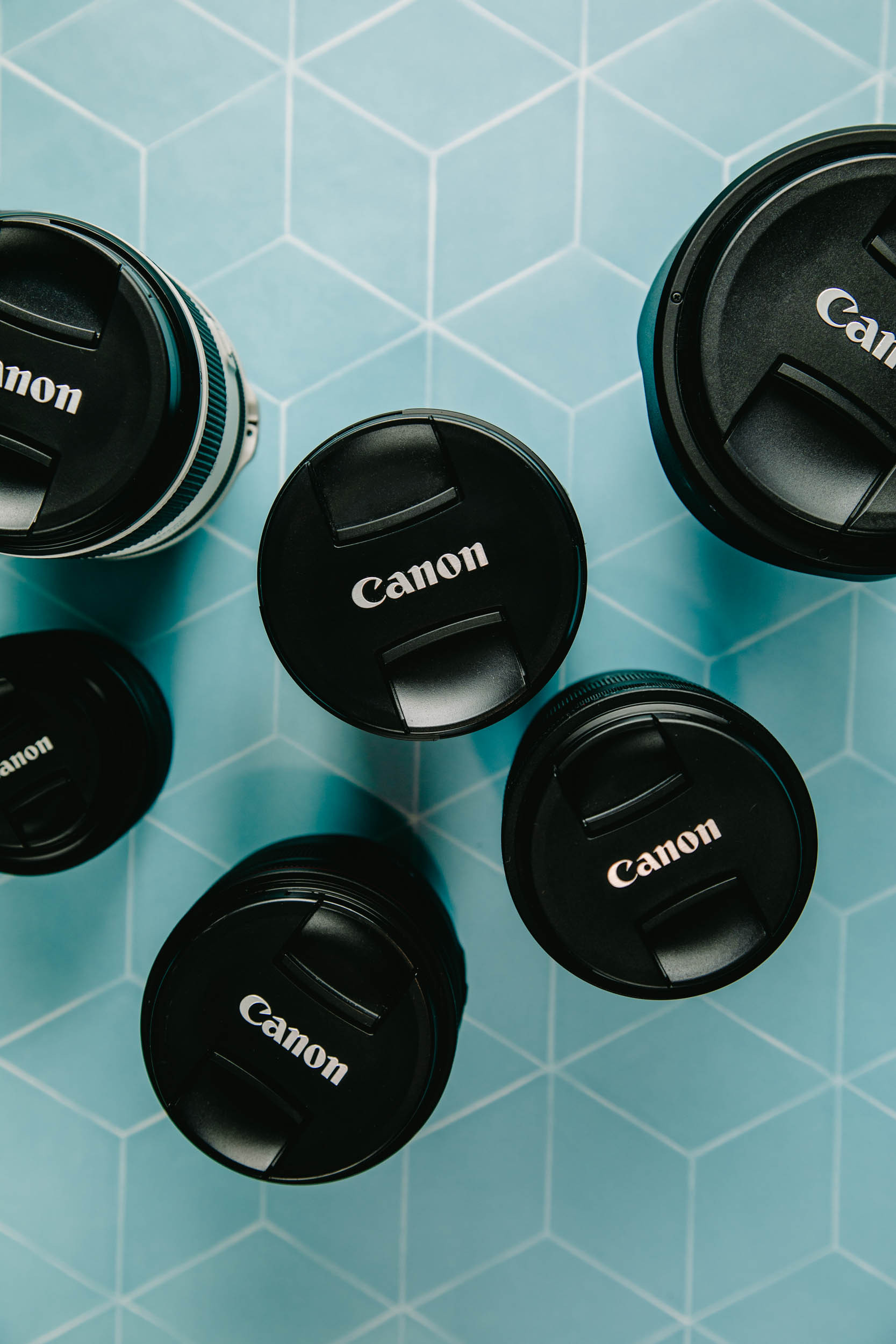 Canon RF lens perched atop a detailed map of Hanoi, Vietnam, highlighting the lens's compact design and suitability for urban exploration.
