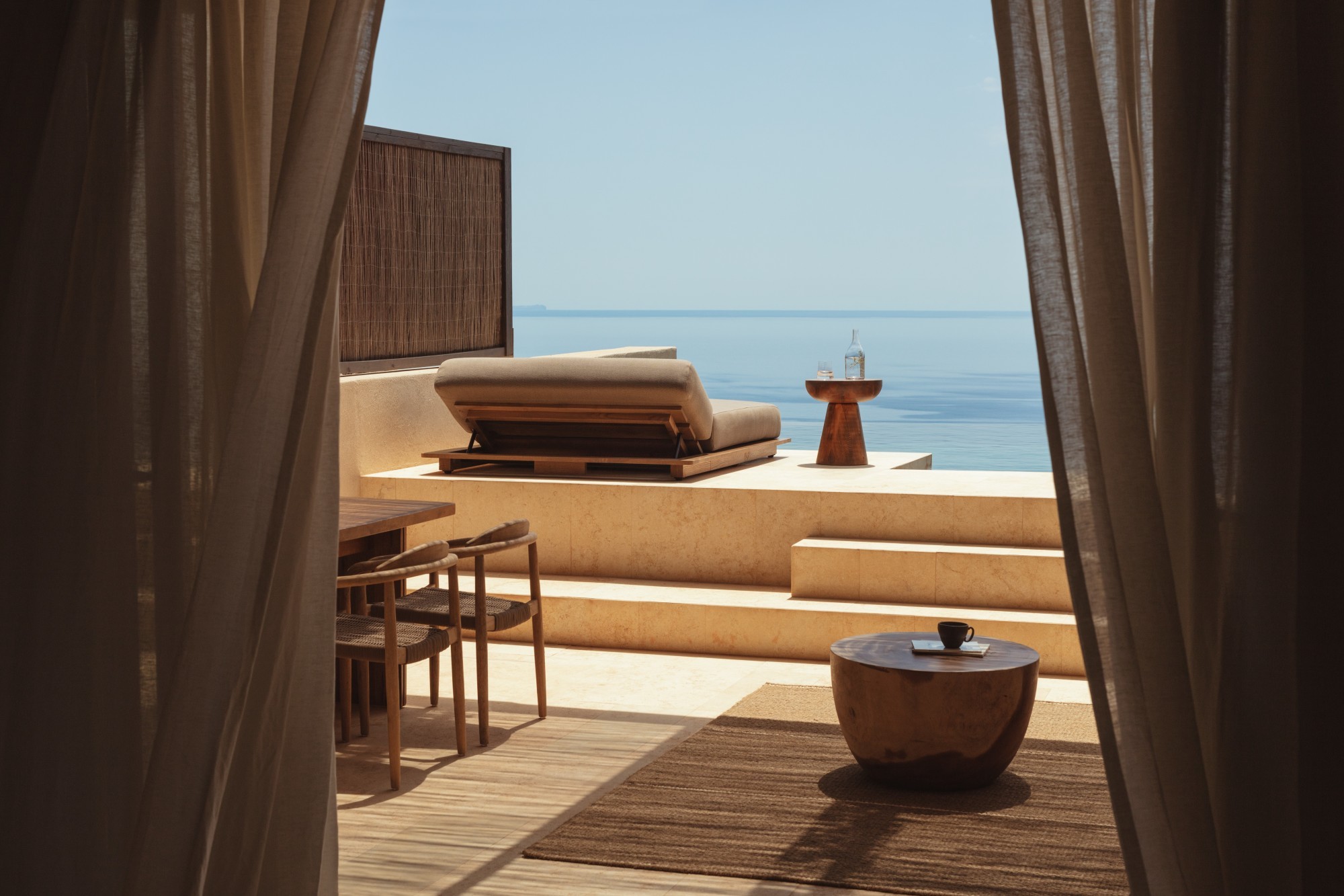 A luxurious terrace with a plunge pool overlooking the ocean, showcasing high-end travel options
