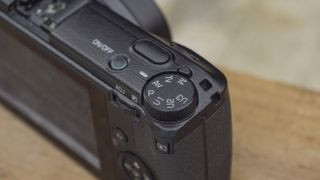 Ricoh GR IIIx camera on a wooden table