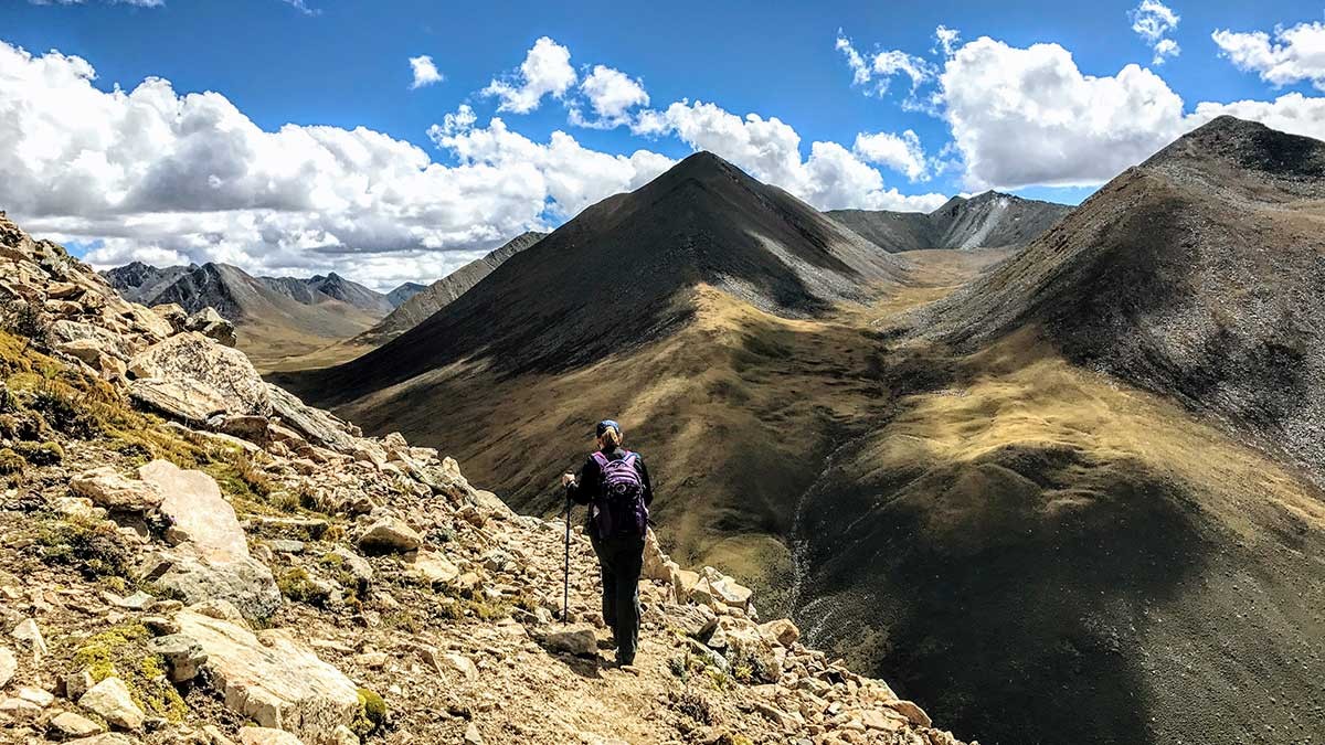 Yolanda coming down from the Zhugar La Pass (17,224 ft/5250 m) on the Ganden Samye Trek in Tibet