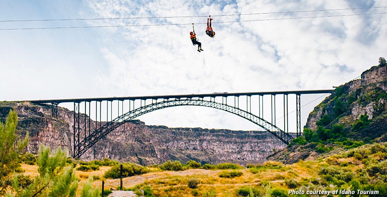Thrill-seekers zipping across the Snake River Canyon with Zip the Snake